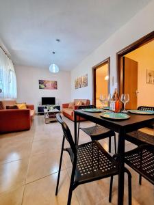 a living room with a table and chairs and a couch at Lemon tree House in Skala Marion +35 photos