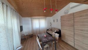 a living room with a table and a couch at Orlická přehrada Chata Malá in Kožlí u Orlíka
