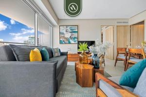 a living room with a couch and a table at New 2BR APT - Beach Access - Pool - GYM - Jacuzzi in Nuevo Vallarta