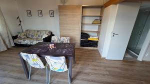 a living room with a table and chairs and a couch at Orlická přehrada Chata Malá in Kožlí u Orlíka