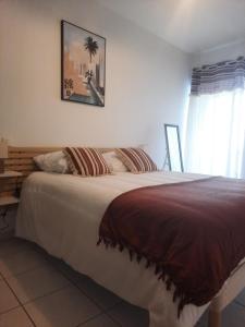 a large bed in a bedroom with a window at Le Gite Boho in Vendeuvre-du-Poitou