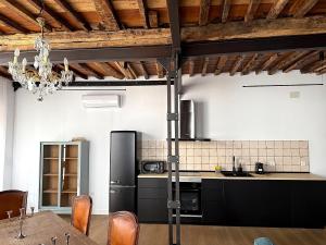 a kitchen with a black refrigerator and a table at Casa Plaza do Millo in Celanova