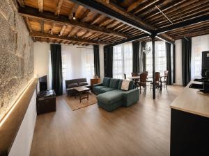 a living room with a couch and a table and chairs at Casa Plaza do Millo in Celanova