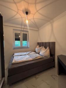 a bedroom with a bed in a room with a ceiling at SC Apartments Bad Goisern - contactless check in in Bad Goisern