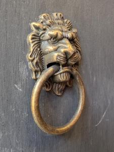 a bronze door knocker of a lion with a handle at Le Boudoir d'Héloïse in Breux Jouy