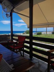 a patio with a table and chairs and the ocean at Chorefto Waves in Chorefto