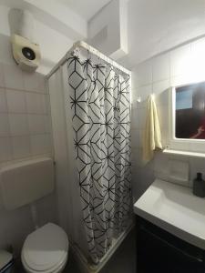 a bathroom with a shower and a toilet and a sink at Chorefto Waves in Chorefto +10 photos