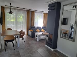 a living room with a blue couch and a table at szemesd6 in Balatonszemes