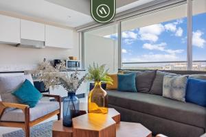 a living room with a couch and a table at New 2BR APT - Beach Access - Pool - GYM - Jacuzzi in Nuevo Vallarta