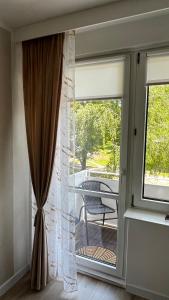 a sliding glass door to a patio with a chair at Apartament Rynek Strzelin in Strzelin