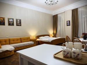 a living room with two beds and a couch at Gallery inn in Kutaisi +19 photos