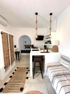a kitchen and living room with a table and a couch at Babatseratsi 3 Apartment in Skiros