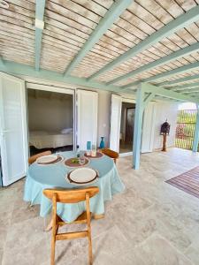a dining room with a table and chairs and a bed at Charmant Bungalow Independant in Grand-Bourg