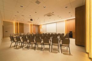 a conference room with chairs and a white screen at Mantra Hotel in Feliz Natal