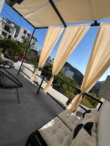 a living room with a couch and a large window at Babatseratsi 3 Apartment in Skiros