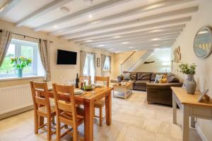 a living room with a table and chairs and a couch at 2 Bed in Abergele oc-88974 in Llanfair Talhaiarn