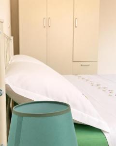 a hospital room with a bed and a green stool at Appartamenti Bellaria Vacanza e Relax in Bellaria-Igea Marina