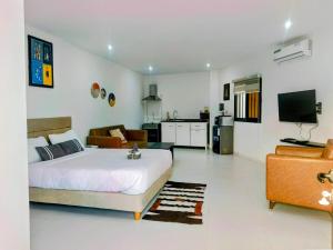 a bedroom with a bed and a living room at Izuba chambres avec vue sur piscine in Ngaparou
