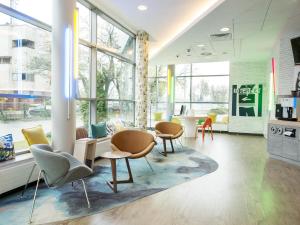 a large room with chairs and tables and windows at ibis budget Warszawa Centrum in Warsaw
