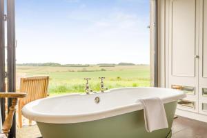 a bath tub in a room with a window at 1 Bed in Wickhambrook oc-tosh in Wickhambrook +10 photos