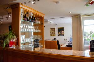 a bar with wine glasses on the wall at Grunau Hotel in Bayreuth