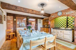 a dining room with a table and a kitchen at 6 Bed in Wangford oc-e31107 in Wangford
