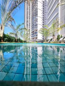 a swimming pool in front of some tall buildings at Studio Moderno A 2 mim do Metrô Sacomã Wi-Fi 600mb | SP Expo in São Paulo