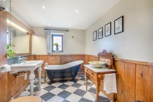 a bathroom with a tub and a sink at 6 Bed in Wangford oc-e31107 in Wangford +31 photos