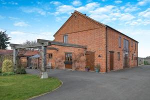 an old brick building with an open garage at 6 Bed in Wangford oc-e31107 in Wangford