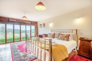 a bedroom with a bed and a large window at 6 Bed in Wangford oc-e31107 in Wangford