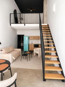 a staircase in a living room with a couch and table at Apartamento Coworking in Novo Sancti Petri