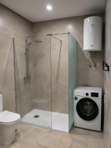 a bathroom with a shower and a washing machine at Apartamento Coworking in Novo Sancti Petri