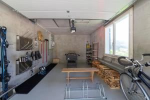 a room with a table and a bike in it at Churfirstenblick in Wildhaus