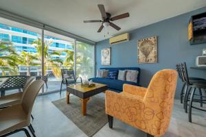 a living room with a couch and a table at Beachfront Duplex with Multiple Pools - Beachclub in Nuevo Vallarta