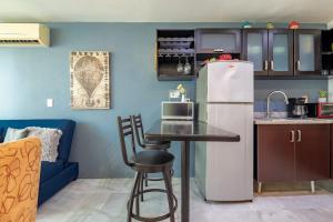 a kitchen with a table and a refrigerator at Beachfront Duplex with Multiple Pools - Beachclub in Nuevo Vallarta