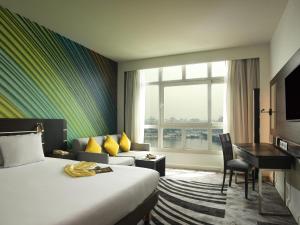 a hotel room with a bed and a desk at Novotel Cairo El Borg in Cairo +96 photos