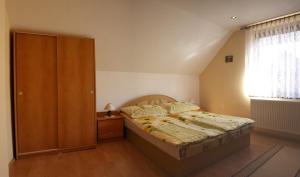 Schlafzimmer mit einem Bett und einem Holzschrank in der Unterkunft Chalupa Evka in Terchová