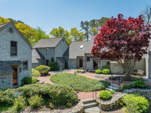 a row of houses with a red tree at Sea Spark - Cape Escape with Pool Access in Mashpee