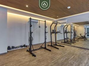 a row of exercise equipment in a fitness room at New 1 BR Condo with Amazing Rooftop Pool - Jacuzzi in Bucerías
