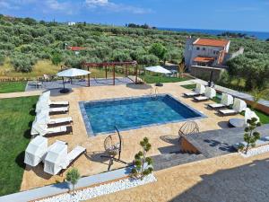 an outdoor swimming pool with chairs and a playground at Resort Finikas in Alexandroupoli