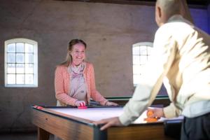 a woman standing in front of a pool table at Høloftet - Charming Vacation Apartment On The 1St Floor Of Hawbakken in Hjørring