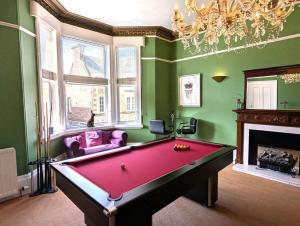 a billiard room with a pool table and a chandelier at 5 Bed in Melrose oc-79418 in Melrose