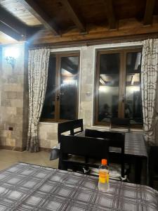 a room with a table and chairs and windows at Hotel Xhejsoni in Shëngjin +28 photos