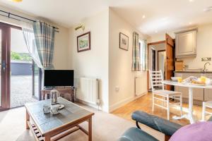 a living room with a couch and a table at 1 Bed in Hope Valley oc-pk849 in Bradwell +8 photos
