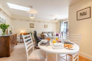 a kitchen and living room with a table and chairs at 1 Bed in Hope Valley oc-pk849 in Bradwell