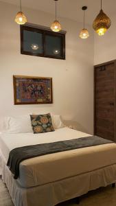 a bedroom with a large white bed with lights at Samaya Wellness Lodge in Flores