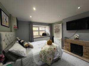 a bedroom with a bed with a teddy bear on it at Cottage 33 in Kirkby Stephen