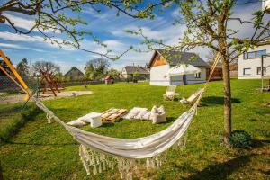 a hammock in a yard with a tree at Apartmány Dalov in Šternberk