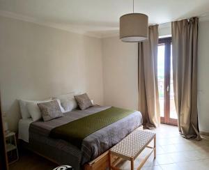 a bedroom with a bed and a large window at Bolsena Cento20 - Rooms & Relax in Bolsena