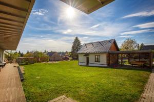 a backyard with a house and a grass yard at Apartmány Dalov in Šternberk